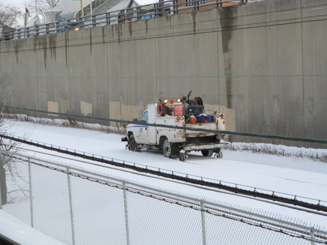 Truck riding on the train tracks.